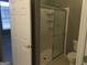 Bathroom showcasing a glass shower stall and toilet, plus a view of the bedroom at 175 Camry Ln, Grayson, GA 30017