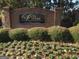 The Villas at Pebble Creek Farm community sign surrounded by greenery at 175 Camry Ln, Grayson, GA 30017