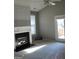 Bright living room features a fireplace, a ceiling fan, and access to the backyard at 175 Camry Ln, Grayson, GA 30017