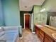 Bathroom boasts a soaking tub, tiled floors, and granite countertops at 9108 Alden Dr, Locust Grove, GA 30248