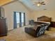 Comfortable main bedroom boasts a vaulted ceiling, a ceiling fan, and neutral paint at 9108 Alden Dr, Locust Grove, GA 30248
