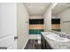 Bathroom features a granite vanity, mirror and dark plank flooring, shower with neutral colored curtain at 9046 Holder Rd, Locust Grove, GA 30248