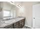 Bright bathroom featuring double sink vanity with granite countertop and decorative lighting at 9046 Holder Rd, Locust Grove, GA 30248