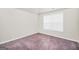 Bright bedroom with a window overlooking trees and soft carpeting for comfort at 9046 Holder Rd, Locust Grove, GA 30248