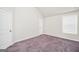Comfortable bedroom with a window for natural light, plush carpet, and white trim at 9046 Holder Rd, Locust Grove, GA 30248