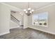 Elegant dining room with hardwood floors, chandelier, and ample natural light from the window at 9046 Holder Rd, Locust Grove, GA 30248
