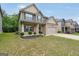 Inviting two-story home with a well-kept lawn, featuring a classic brick and siding exterior at 9046 Holder Rd, Locust Grove, GA 30248
