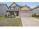 Charming two-story home features a brick facade, two-car garage, and well-manicured lawn at 9046 Holder Rd, Locust Grove, GA 30248