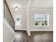 Sunlit foyer with hardwood floors, a staircase, and a clear view to the outside at 9046 Holder Rd, Locust Grove, GA 30248