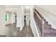 Bright foyer with hardwood floors, staircase, and a view into the adjacent living spaces at 9046 Holder Rd, Locust Grove, GA 30248