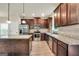 Bright kitchen with dark wood cabinets, stainless steel appliances, and granite countertops at 9046 Holder Rd, Locust Grove, GA 30248