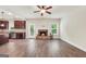 Bright living room with open-concept access to brick fireplace and the kitchen at 9046 Holder Rd, Locust Grove, GA 30248