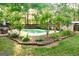 Backyard with a refreshing swimming pool, patio, and lush trees at 110 Orchard Vw, Fayetteville, GA 30215
