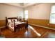 Cozy bedroom with wood floors, natural light, a decorative bedspread, and a ceiling fan promoting relaxation at 110 Orchard Vw, Fayetteville, GA 30215