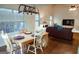 Bright dining area featuring a wooden table, light-colored chairs, and hardwood floors, flowing into the living area at 110 Orchard Vw, Fayetteville, GA 30215