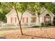 Charming home featuring a white picket fence, complemented by trees and light-colored siding with red shutters at 110 Orchard Vw, Fayetteville, GA 30215