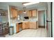 Well-lit kitchen featuring wood cabinets, stainless steel appliances, and tile flooring at 110 Orchard Vw, Fayetteville, GA 30215