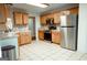 Modern kitchen features tile floors, stainless appliances, and light oak cabinets providing ample storage and prep space at 110 Orchard Vw, Fayetteville, GA 30215