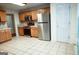 Bright kitchen features stainless steel appliances, light oak cabinets, and tile floors, offering a clean, modern aesthetic at 110 Orchard Vw, Fayetteville, GA 30215