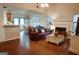 Cozy living room with hardwood floors, a fireplace, and a comfortable leather sofa, leading to the dining area at 110 Orchard Vw, Fayetteville, GA 30215