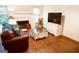 Cozy living room featuring hardwood floors, a fireplace, and a comfortable leather sofa at 110 Orchard Vw, Fayetteville, GA 30215