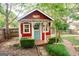 Charming red pool house with white trim, a quaint porch, and inviting curb appeal at 110 Orchard Vw, Fayetteville, GA 30215