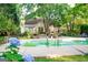 Backyard swimming pool with poolside seating, meticulous landscaping, and mature shade trees at 110 Orchard Vw, Fayetteville, GA 30215