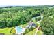 Aerial view showcasing a pool, tennis courts, and well manicured landscaping at 120 Lapis Lake Pt, Fayetteville, GA 30215