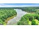 Aerial view of a lake surrounded by lush forests and homes at 120 Lapis Lake Pt, Fayetteville, GA 30215