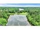 Overhead view showcasing a lake surrounded by lush forests and homes at 120 Lapis Lake Pt, Fayetteville, GA 30215