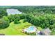 Aerial view featuring a community pool and a lake surrounded by lush forests at 120 Lapis Lake Pt, Fayetteville, GA 30215