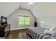 Cozy bedroom with sloped ceiling, window, and furniture at 120 Lapis Lake Pt, Fayetteville, GA 30215