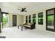 Spacious covered deck with ceiling fan and cushioned seating at 120 Lapis Lake Pt, Fayetteville, GA 30215