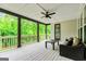 Covered deck with ceiling fan and comfortable seating overlooks green trees at 120 Lapis Lake Pt, Fayetteville, GA 30215