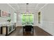 Bright dining room with hardwood floors, wainscotting and large windows overlooking the yard at 120 Lapis Lake Pt, Fayetteville, GA 30215