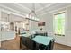 Bright dining room showcasing modern table, stylish chandelier, and seamless connection to the open-concept kitchen at 120 Lapis Lake Pt, Fayetteville, GA 30215