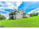A view of the house with a large lawn, a covered porch and large windows at 120 Lapis Lake Pt, Fayetteville, GA 30215