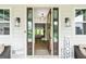 An open doorway welcomes you into a well-lit living area with hardwood floors and fireplace at 120 Lapis Lake Pt, Fayetteville, GA 30215
