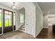 Inviting foyer with hardwood floors, stairs, and a dark wood front door with sidelights at 120 Lapis Lake Pt, Fayetteville, GA 30215