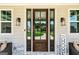 Inviting front door featuring sidelights, stone accents, and cozy seating at 120 Lapis Lake Pt, Fayetteville, GA 30215