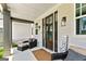 Charming front porch featuring a seating area with stylish decor elements and natural light at 120 Lapis Lake Pt, Fayetteville, GA 30215