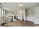 Bright hallway features hardwood floors, white trim, and staircase with metal railing at 120 Lapis Lake Pt, Fayetteville, GA 30215