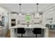 Bright kitchen with white cabinets, stainless steel appliances, and a quartz island with seating at 120 Lapis Lake Pt, Fayetteville, GA 30215