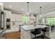 Bright kitchen with a large island with seating, stainless steel appliances, and white cabinets at 120 Lapis Lake Pt, Fayetteville, GA 30215