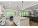 Open-concept kitchen featuring a quartz island, white cabinets and stainless steel appliances at 120 Lapis Lake Pt, Fayetteville, GA 30215