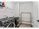 Functional laundry room features modern washer and dryer, ample shelving, and efficient layout at 120 Lapis Lake Pt, Fayetteville, GA 30215