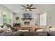 Cozy living room featuring a stone fireplace, hardwood floors, and a large TV above the mantel at 120 Lapis Lake Pt, Fayetteville, GA 30215