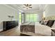 Airy main bedroom features a private balcony, large window, and elegant dark wood dresser at 120 Lapis Lake Pt, Fayetteville, GA 30215