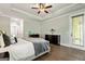 Cozy main bedroom with tray ceilings, a private balcony, and stylish dark wood dresser at 120 Lapis Lake Pt, Fayetteville, GA 30215