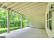 Covered patio with concrete floor, pillars, exposed beams, and view of trees at 120 Lapis Lake Pt, Fayetteville, GA 30215